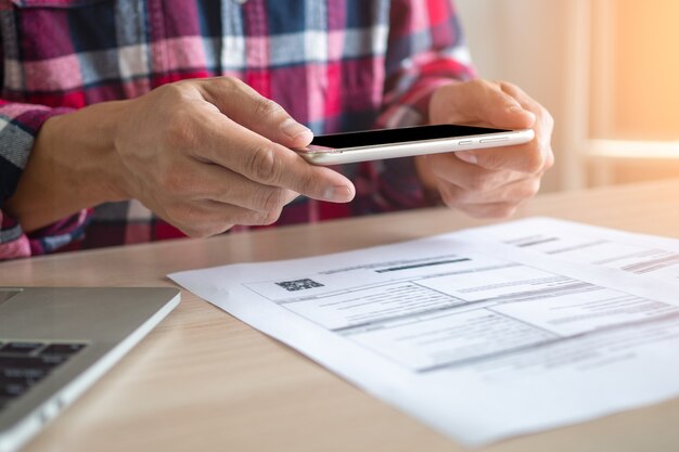 Homme utilisant le téléphone pour scanner le code à barres