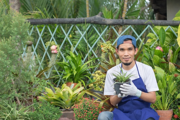 L'homme vend un jardin de plantes en magasin