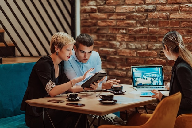 Des hommes d'affaires heureux souriant joyeusement lors d'une réunion dans un café Groupe de professionnels d'affaires prospères travaillant en équipe dans un lieu de travail multiculturel