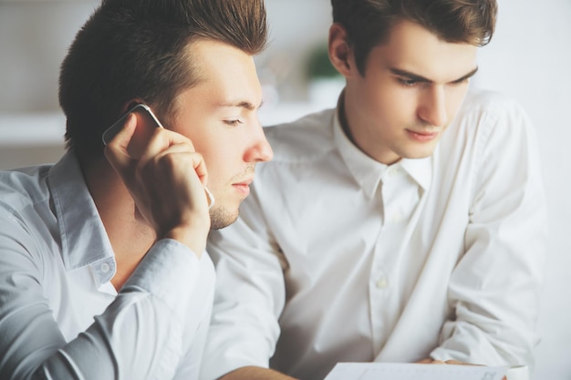 Hommes attirants parlant au téléphone