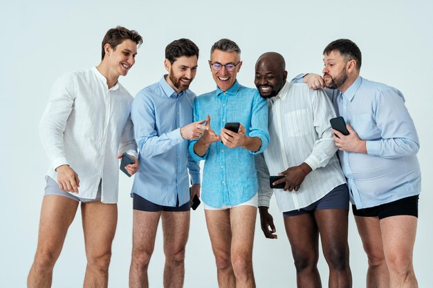 Hommes multiethniques posant pour un ensemble de beauté positive pour le corps masculin. les gars d'âge différent et le corps portant des sous-vêtements et une chemise de boxeurs