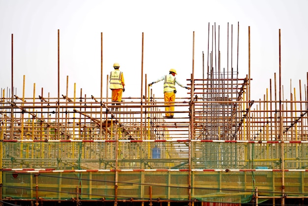 Des hommes travaillent sur un chantier contre un ciel dégagé.