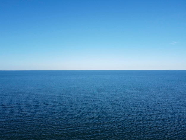 Horizon bleu où convergent le ciel sans nuages et la mer bleue