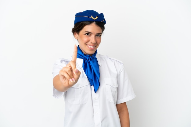 Hôtesse d'avion femme caucasienne isolée sur fond blanc montrant et levant un doigt