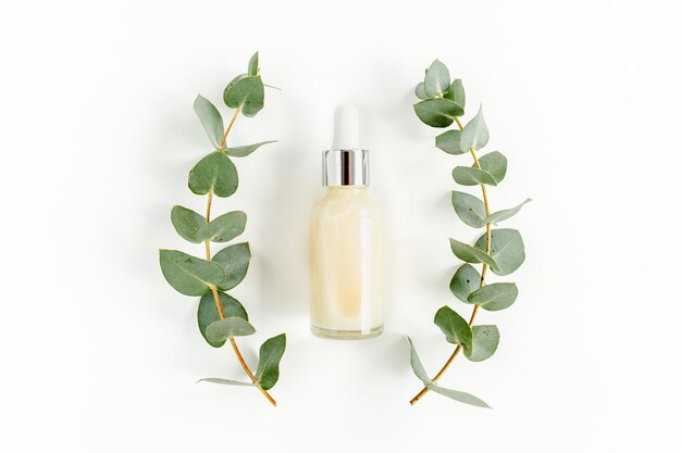 Huile essentielle d'eucalyptus feuilles d'eucalyptus sur fond blanc produits cosmétiques bio naturels moi