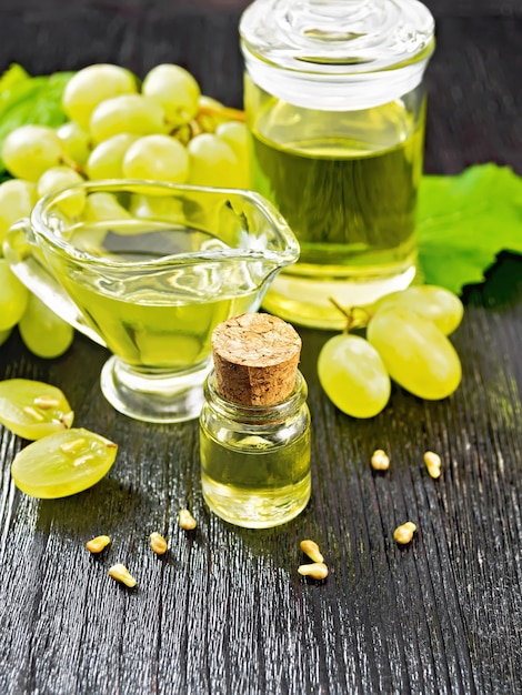 huile de raisin en bouteille, saucière et bocal, baies et pépins de raisins verts