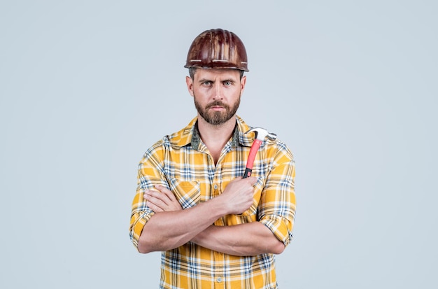 Il est prêt. homme architecte avec marteau. le gars porte un uniforme de travailleur. beau constructeur en casque. homme mûr porter une chemise à carreaux. constructeur ou mécanicien professionnel. ingénieur constructeur.