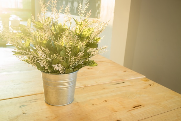 Il suffit de planter un seau décoré sur une table en bois