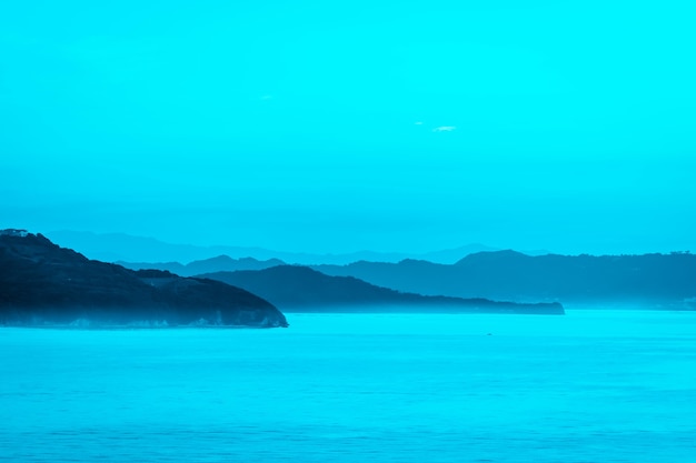 Photo Île de silhouette avec coucher de soleil sur fond clair coloré pour paradis couleur exotique pour fond de vacances et de voyage