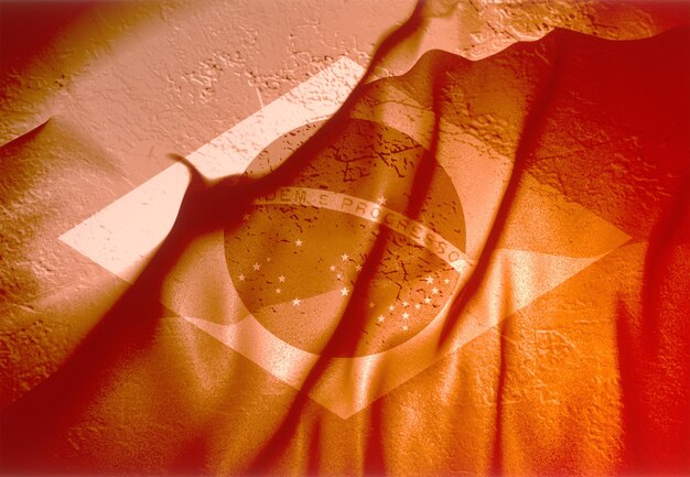 Photo illustration 3d du drapeau du brésil sur une surface bosselée texturée orange