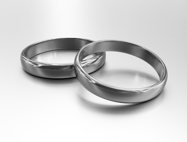 Photo illustration de deux anneaux de mariage en argent se trouvent l'un sur l'autre