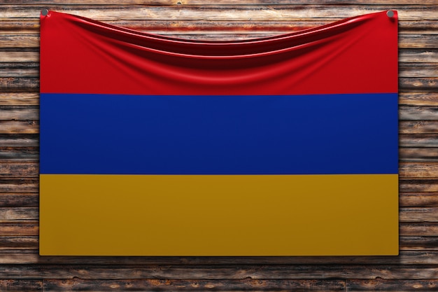 Illustration du drapeau national en tissu de l'Arménie cloué sur un mur en bois
