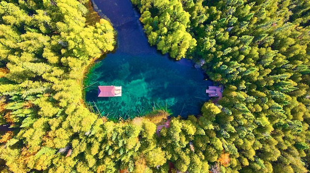 Image de l'antenne d'un lac avec un bateau qui tire sur une corde tournée vers le bas avec une rivière