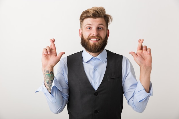 Image d'un beau jeune homme barbu nerveux debout isolé sur un mur blanc faire signe d'espoir s'il vous plaît.