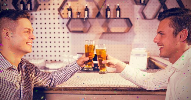 Photo image composée de deux hommes grillant un verre de bière