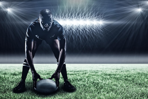 Image composée du sportif tenant la boule tout en jouant au rugby et à la 3d