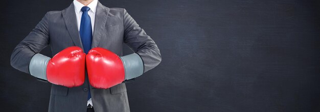 Image composée d'homme d'affaires avec des gants de boxe