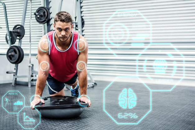 Image composite du portrait d'un homme musclé à l'aide de bosu ball