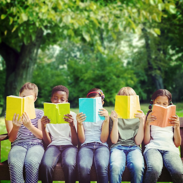 Photo image composite d'enfants lisant des livres au parc