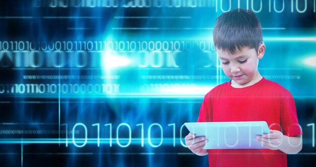Image composite d'un garçon debout à l'aide d'une tablette