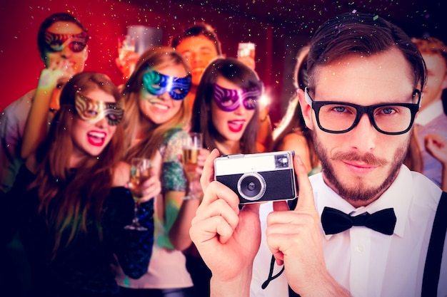 Photo image composite de hipster geek tenant un appareil photo rétro