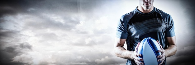 Image composite de rugby player holding ball