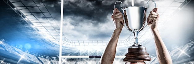 Photo image composite de rugby player holding trophy