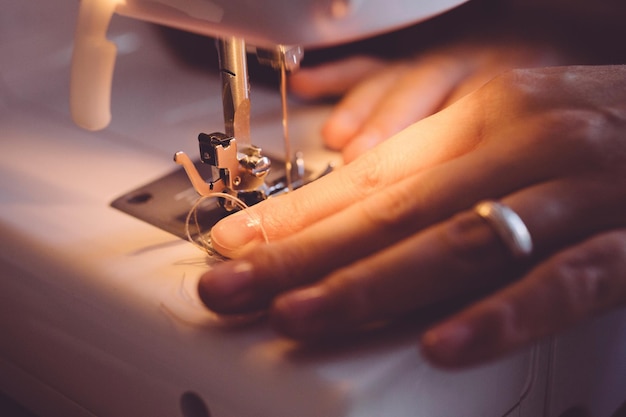 Image coupée d'une femme utilisant une machine à coudre