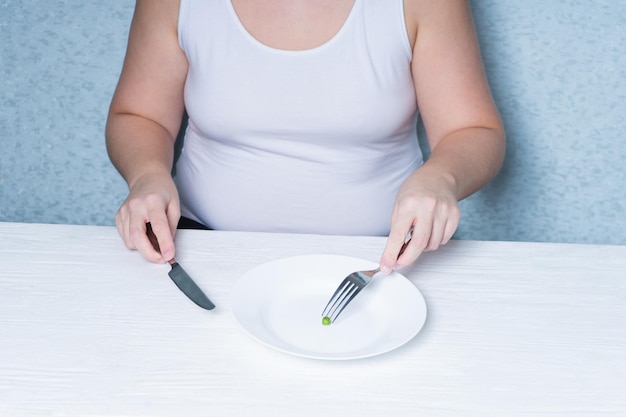 Image coupée d'une fille mangeant des pois régime de perte de poids Trouble de l'alimentation