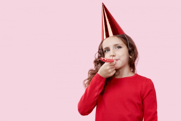 L'image d'une jeune fille souriante dans une robe rouge, célébrant l'anniversaire de sa mère.