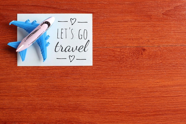 Photo image vue de dessus d'un avion jouet et d'un papier bleu avec texte let's go travel espace de copie pour le texte