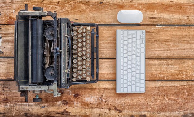 Photo immédiatement au-dessus de la photo du clavier d'ordinateur et de la machine à écrire sur la table