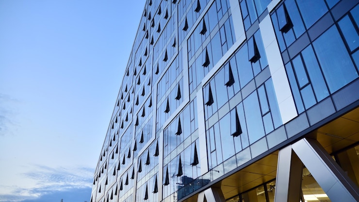 Photo immeuble de bureaux moderne avec façade en verre sur fond de ciel clair mur de verre transparent