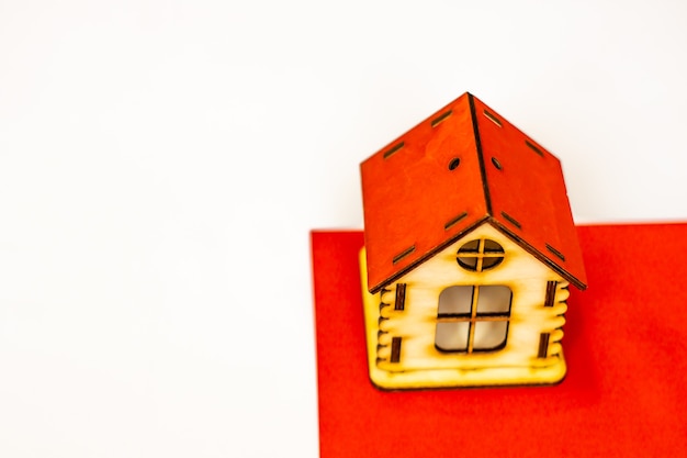 Immobilier en SuisseMaison en bois sur le drapeau suisse Concept de location ou d'hypothèque de propriété