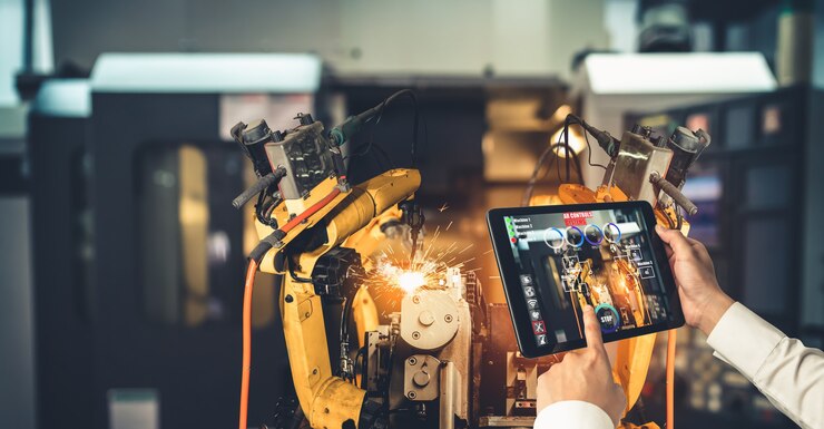 Photo un ingénieur contrôle des bras robotiques grâce à la technologie de l'industrie de la réalité augmentée
