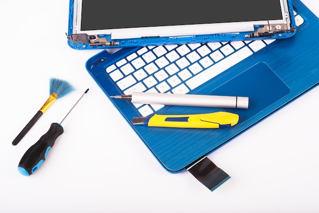 Photo l'ingénieur répare l'ordinateur portable bleu et le remplacement de l'écran de l'ordinateur portable installe le processeur de l'équipement