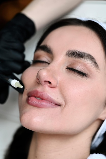 Injection de beauté Femme faisant la correction de son nez et de ses lèvres dans le salonxD