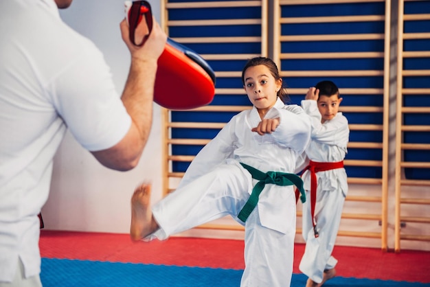 Instructeur de tae kwon do sur la formation avec les enfants