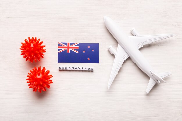Interdiction de vol et fermeture des frontières pour les touristes et les voyageurs atteints de coronavirus covid-19. Avion et drapeau de la Nouvelle-Zélande sur fond blanc. Pandémie de Coronavirus.