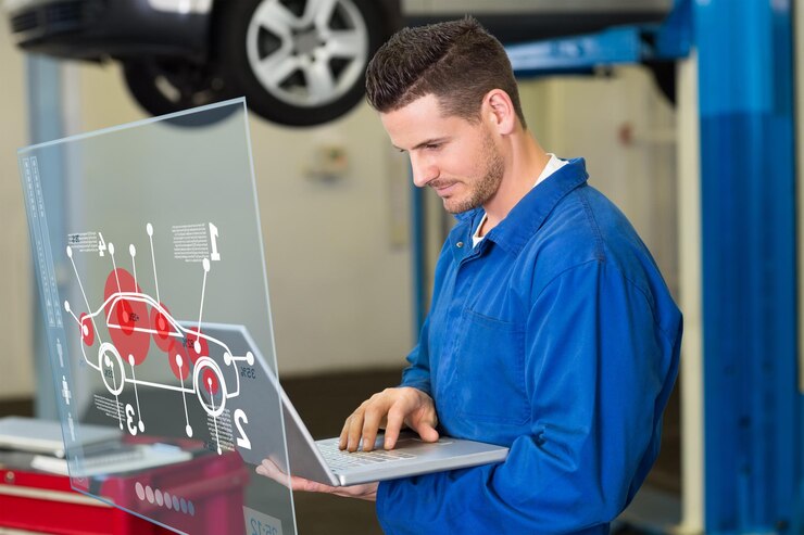 Photo interface voiture contre mécanicien utilisant un ordinateur portable pour travailler