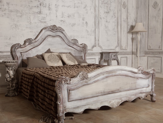 Intérieur d'une chambre , Lit romantique en bois, tons blancs.