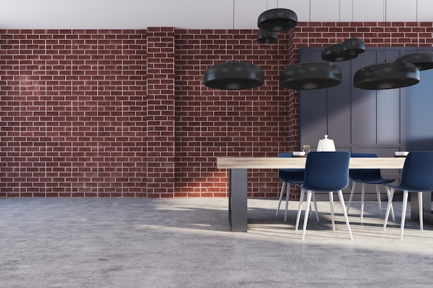 Intérieur de cuisine en brique avec un sol en béton, une table en bois massive et des chaises noires. Un placard noir en arrière-plan. maquette de rendu 3d
