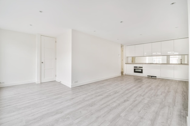 Intérieur de la cuisine à domicile vide avec des appareils contemporains. Un grand studio avec cuisine et murs blancs