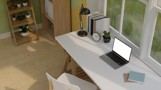 Intérieur minimaliste de la salle de bureau à domicile scandinave avec maquette d'ordinateur portable sur la table contre la fenêtre