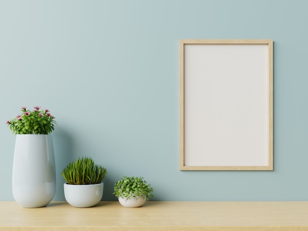 Intérieur avec des plantes, cadre sur un mur bleu vide b