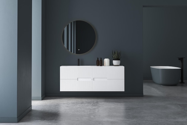 Intérieur de salle de bain minimaliste moderne, armoire de salle de bain moderne, lavabo blanc, miroir ovale, béton.