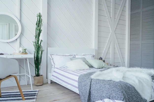 Intérieur scandinave moderne et écologique avec table blanche et miroir dans la chambre