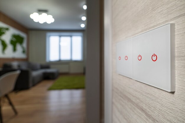 Photo un interrupteur d'éclairage moderne blanc sur un mur blanc sur le fond du salon. design moderne.
