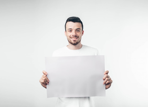 Isolé sur fond blanc l'homme tient une affiche barbu