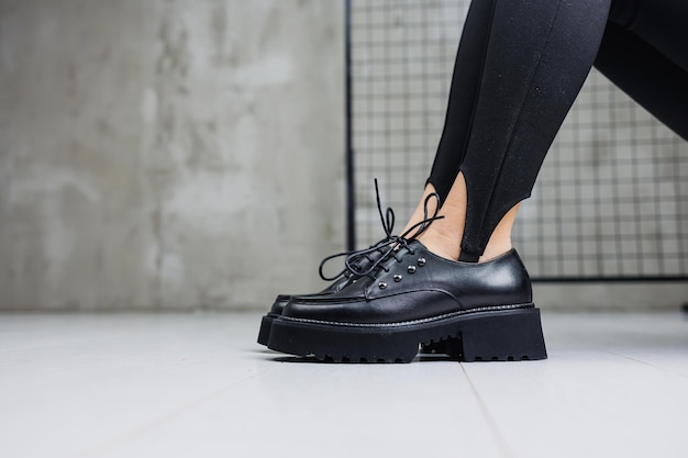 Jambes élancées pour femmes en leggings noirs et mocassins en cuir noir gros plan Chaussures printemps-été pour femmes 2023